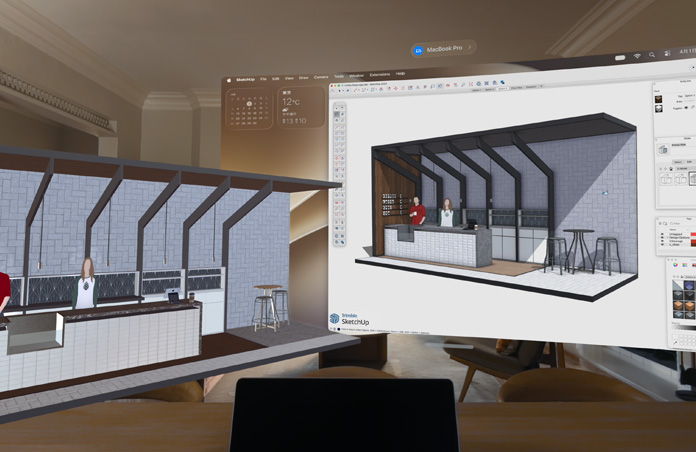 Apple Vision Proのビュー。台の上にMacBook Proが置かれ、その背後に3Dモデルが表示されている。モデルには、カフェのサービスカウンターとその奥側に立つ2人の人物が映し出される