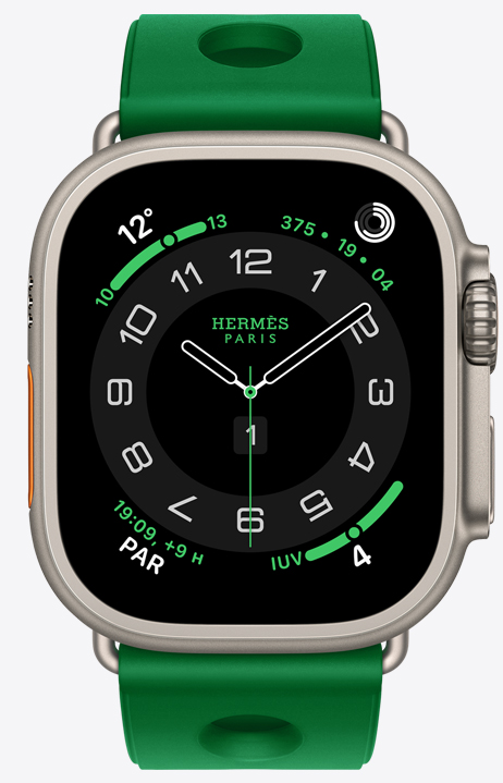 Apple Watch Hermès Ultra 4, carátula analógica Circulaire, (agujas de hora, minuto y segundo, complicaciones: Clima, círculos de Actividad, hora de París e Índice UV), caja de titanio, color natural, parte lateral derecha, Digital Crown, botón lateral en relieve, con la correa Scub'H Diving, color Vert Vertigo (verde brillante), fabricada con goma moldeada, aberturas circulares en el centro