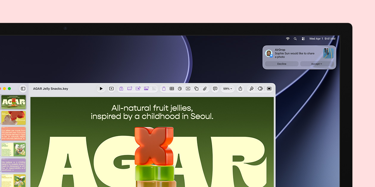 Studio&nbsp;Display screen showcases a Keynote about jelly snacks, a notification in the upper-right corner of the screen shows a request from another person to share a photo